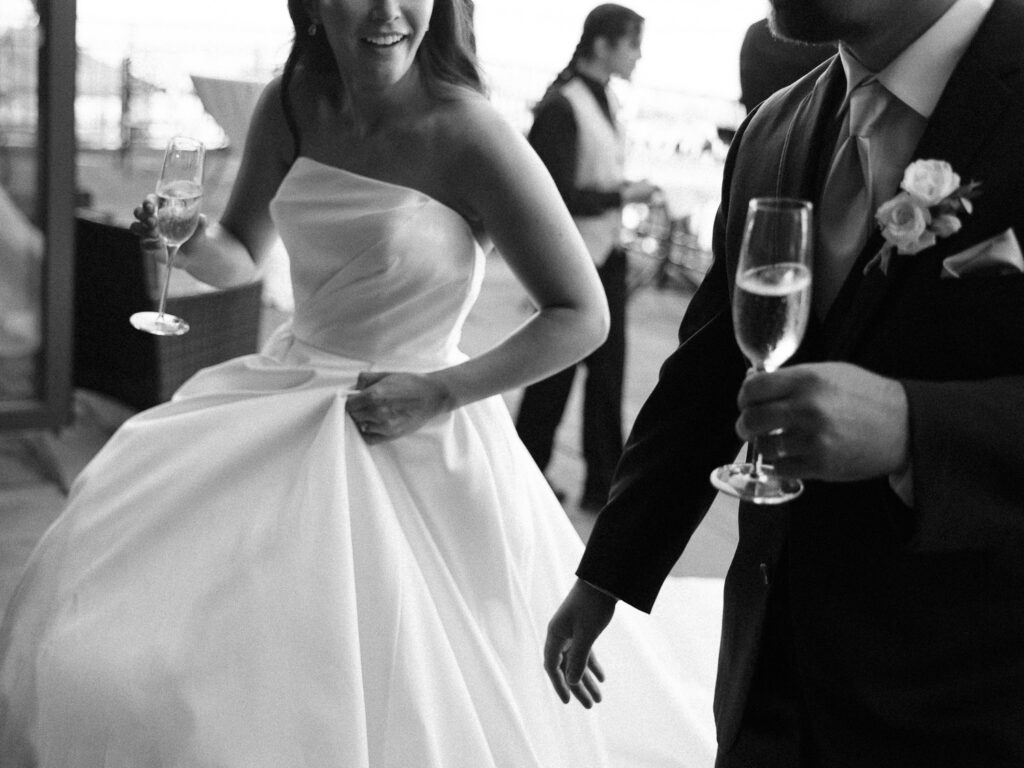 Champagne toasts accompany the bride and groom as they walk into their unique wedding reception.