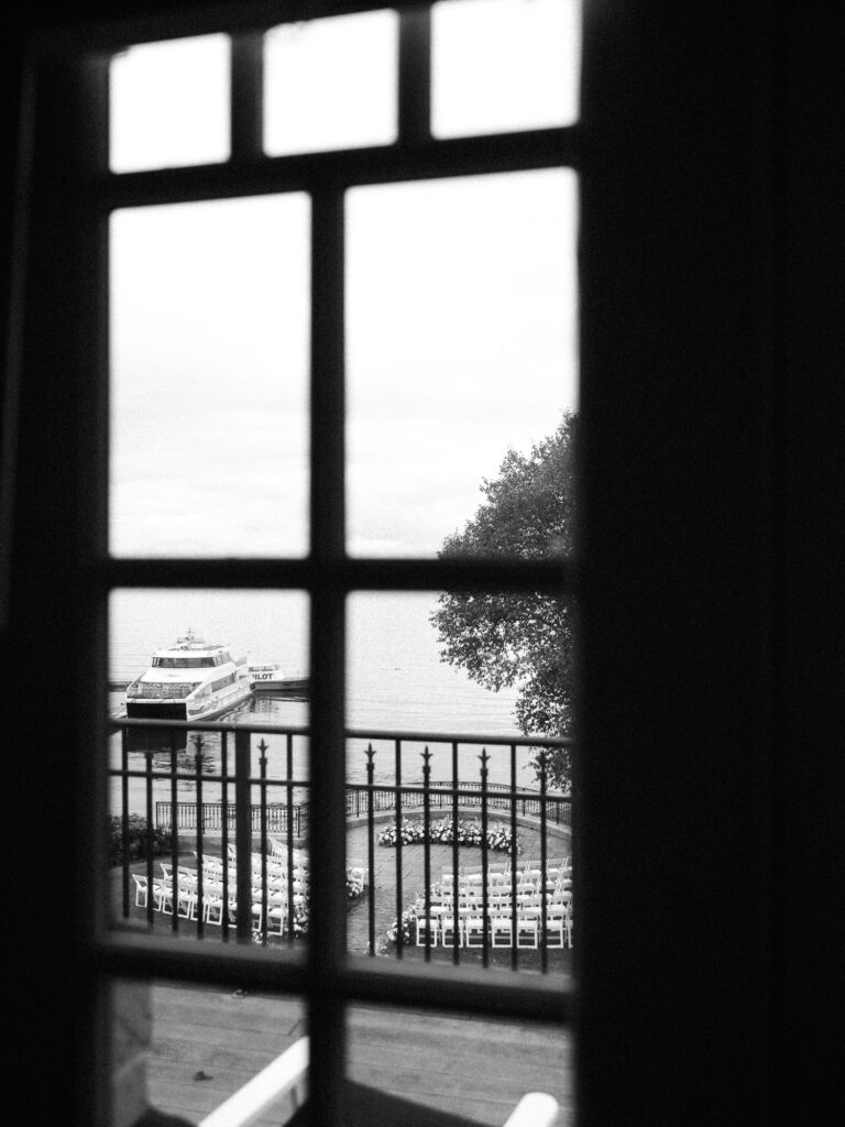 Documentary wedding photo of a ceremony location through the windowpane of a victorian cottage in Bar Harbor, Maine, USA.