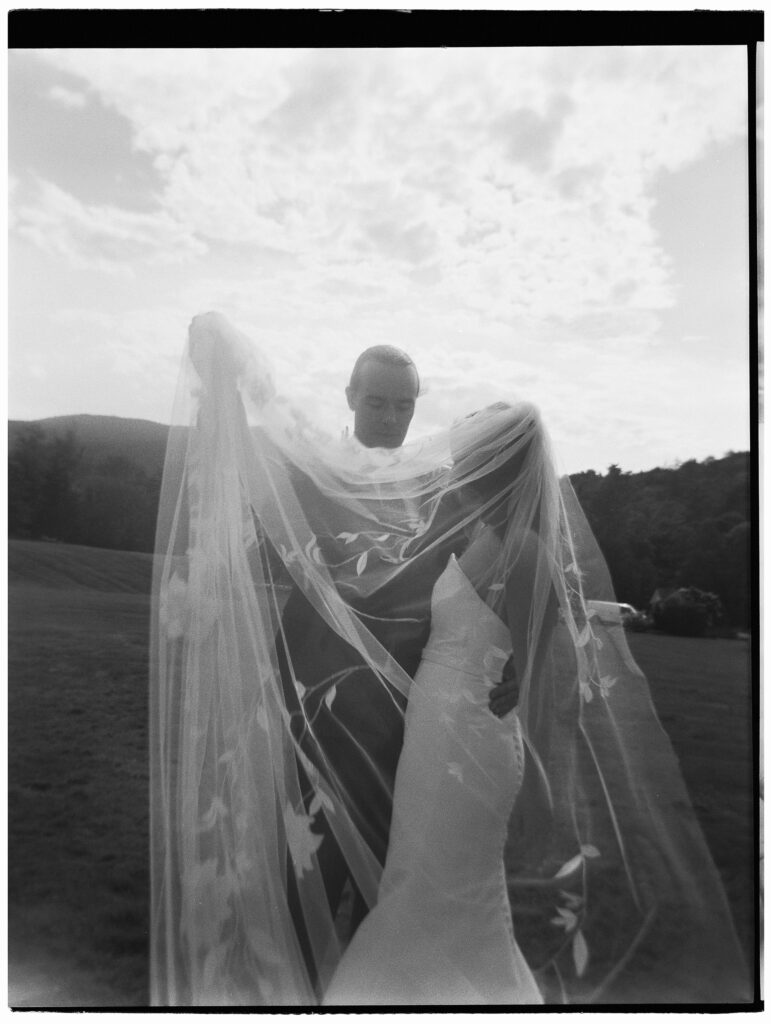Emotional, documentary wedding photography exists in so many ways. This image, of a groom helping a bride untangle her veil was shot on a Holga toy camera by one of the best wedding photographers in Vermont.