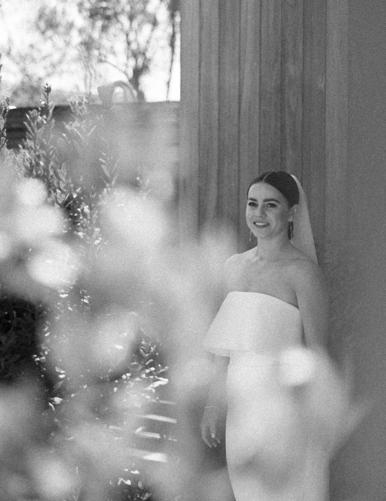 Black and white candid photo of a bride wearing a sleek, modern wedding dress at Stanley Ranch in Napa.