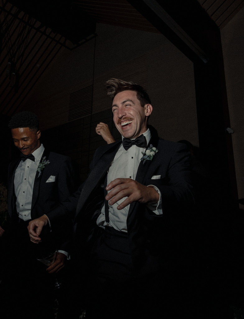 Groomsman laughs wildly while dancing at a wedding in Napa, California.