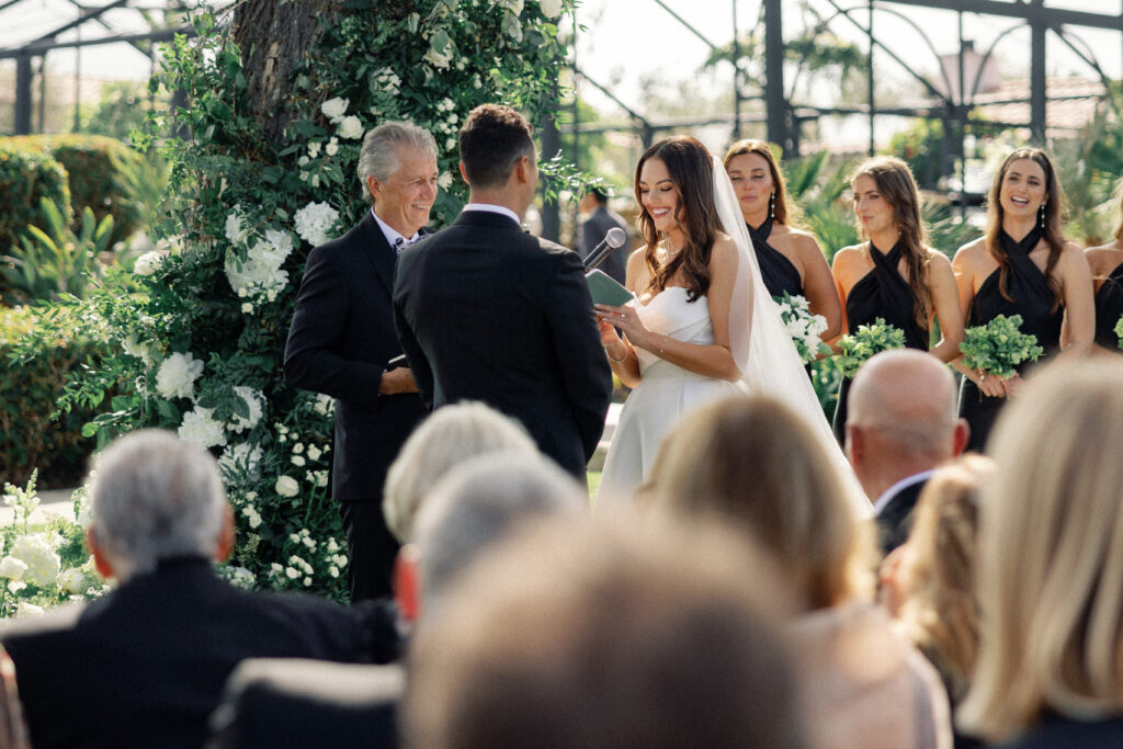 Bride smiles while reading her vows at a wedding in Rancho Santa Fe, California.