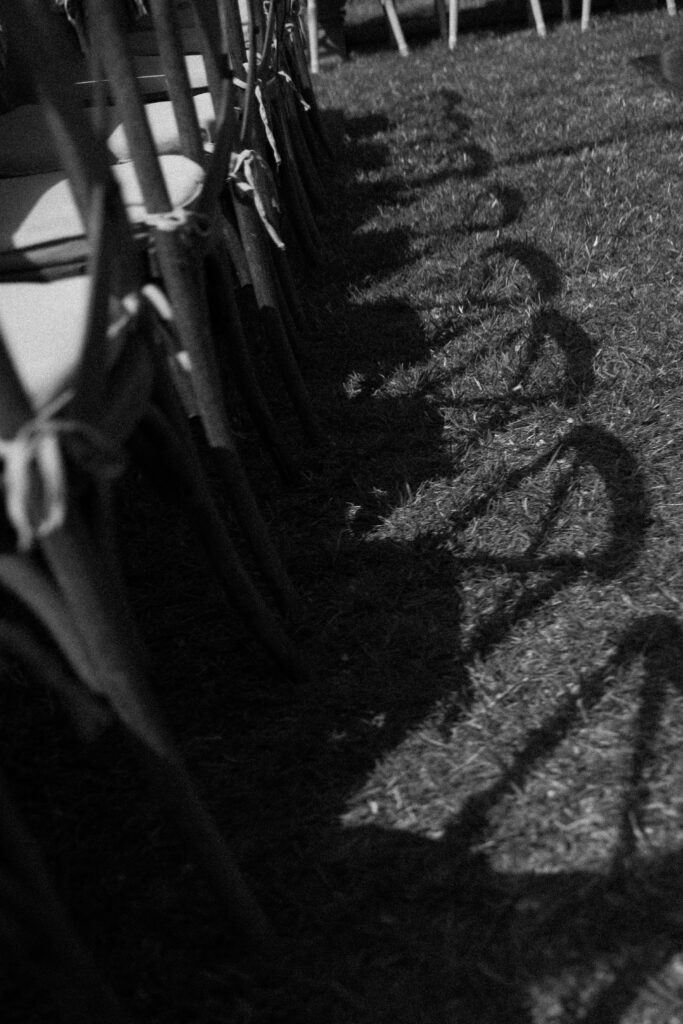 The sun casts shadows on the ground at a wedding in socal.