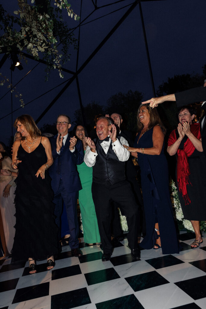 Wedding guests party on the dance floor at a wedding photographed by Kay Cushman.