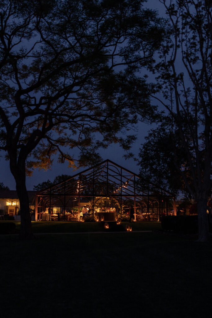 Evening view of a candle-lit wedding reception on the lawn at the inn at Rancho Santa Fe by photographer Kay Cushman.