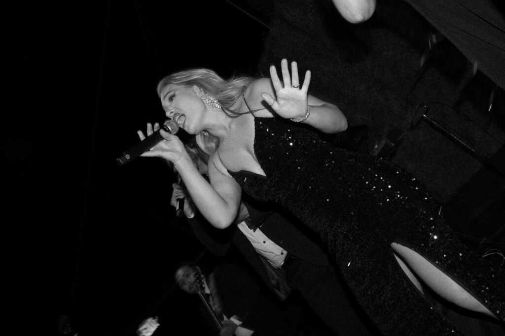 band singer holds microphone while performing at wedding near San Diego, California