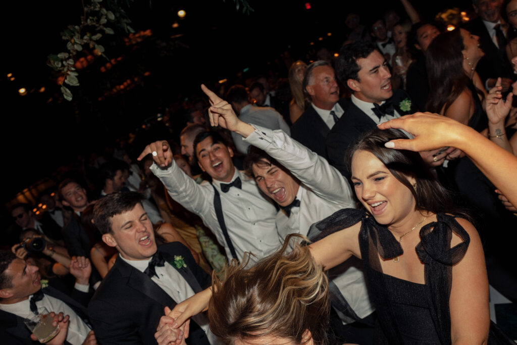 Wedding guests party on the dance floor at a wedding photographed by Kay Cushman.